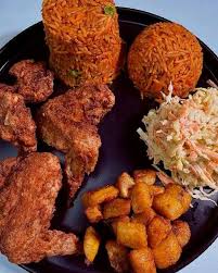 Jollof Rice, salad, plantain, and chicken 